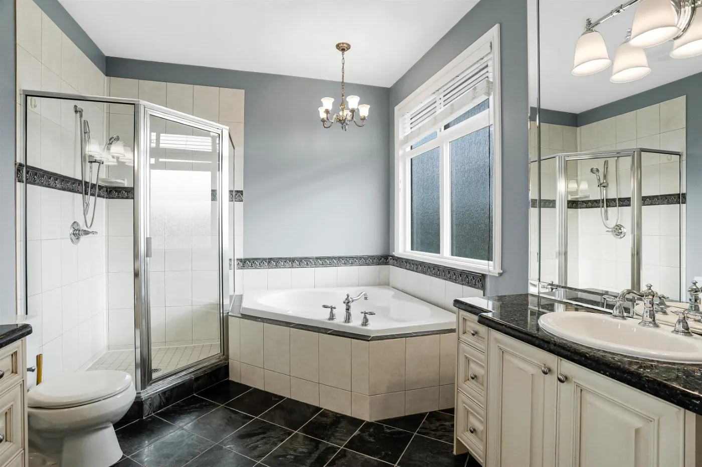 Ensuite with corner soaker tub at 3660 Raymond Ave